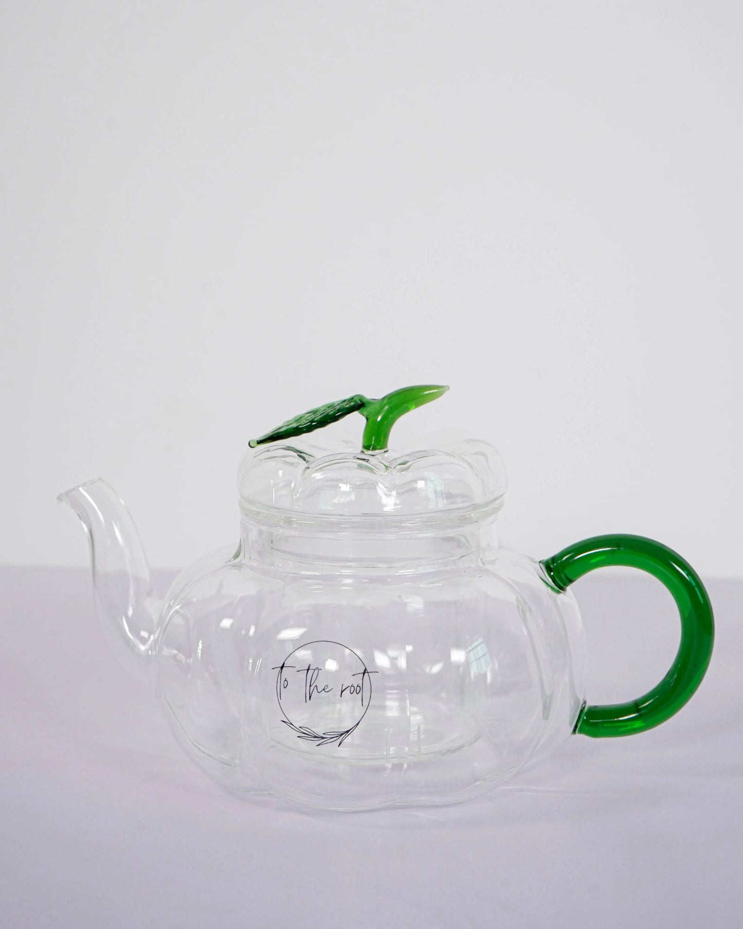 glass pumpkin teapot with green handle