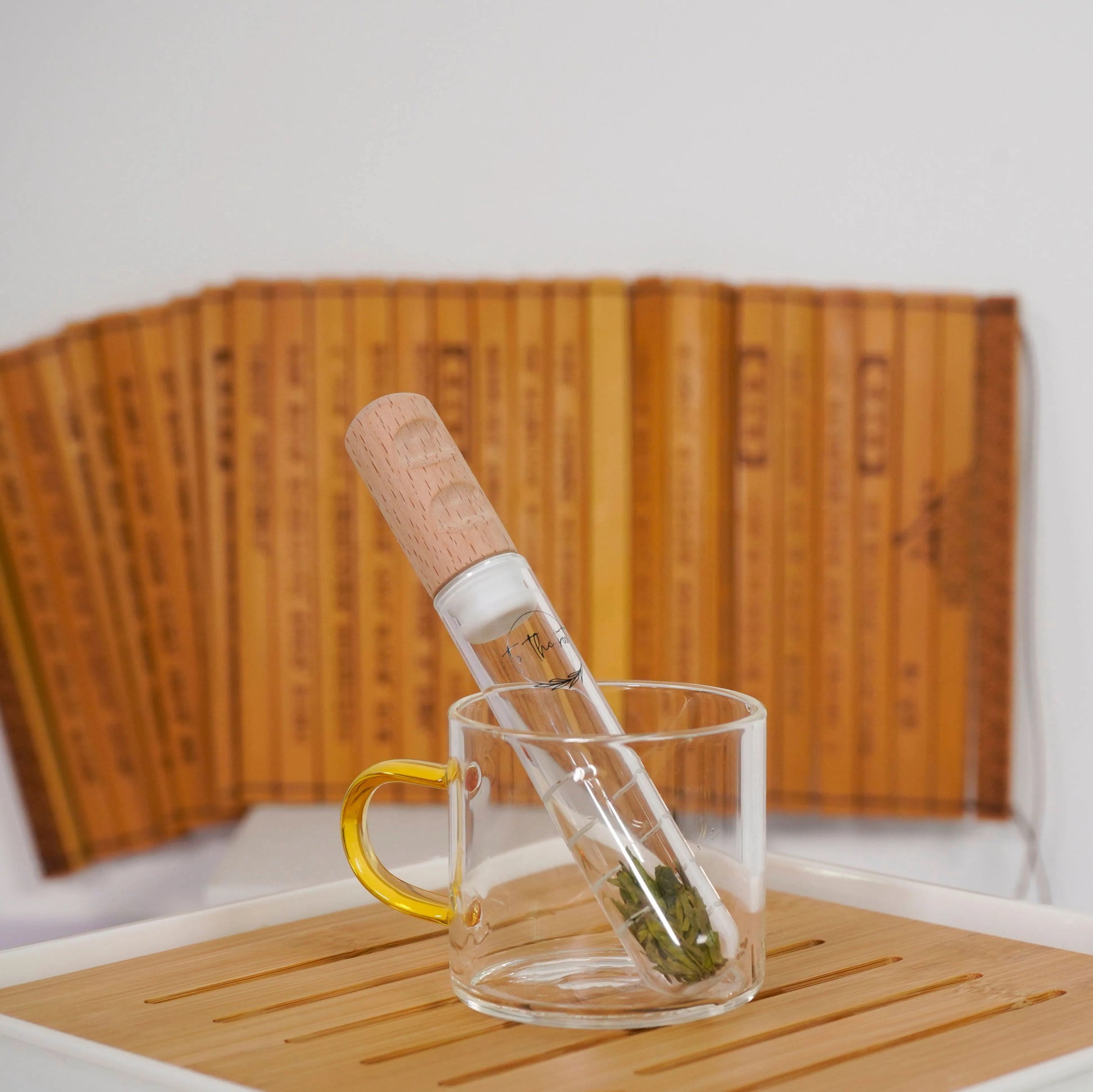 infuser image filled with green tea sitting in a glass cup